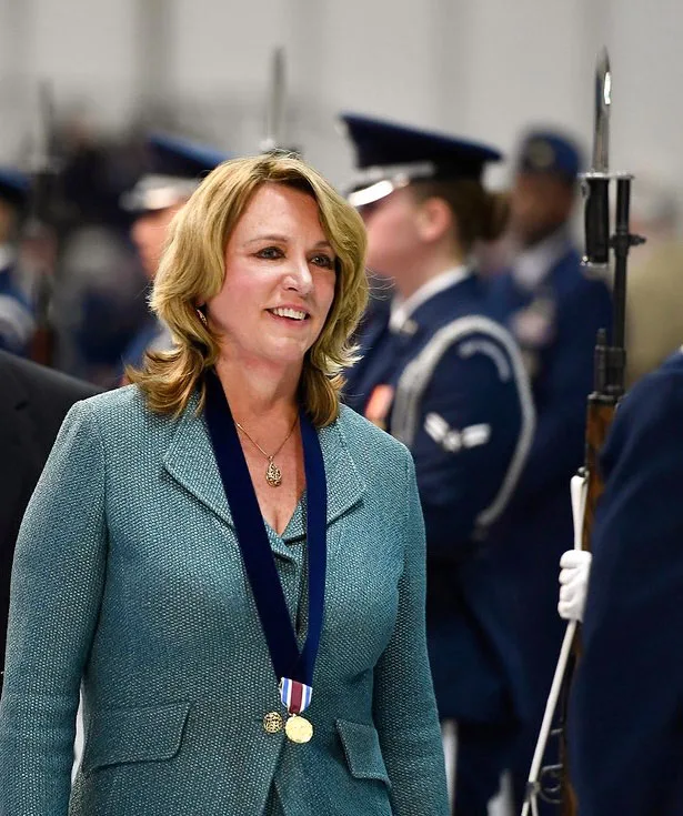 Deborah Lee James walking past an Air Force honor guard